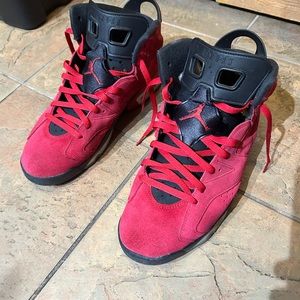 Red and black Jordan 6s , lightly worn . Size 12